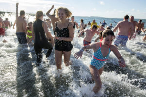 Participants rush out of the cold water. 